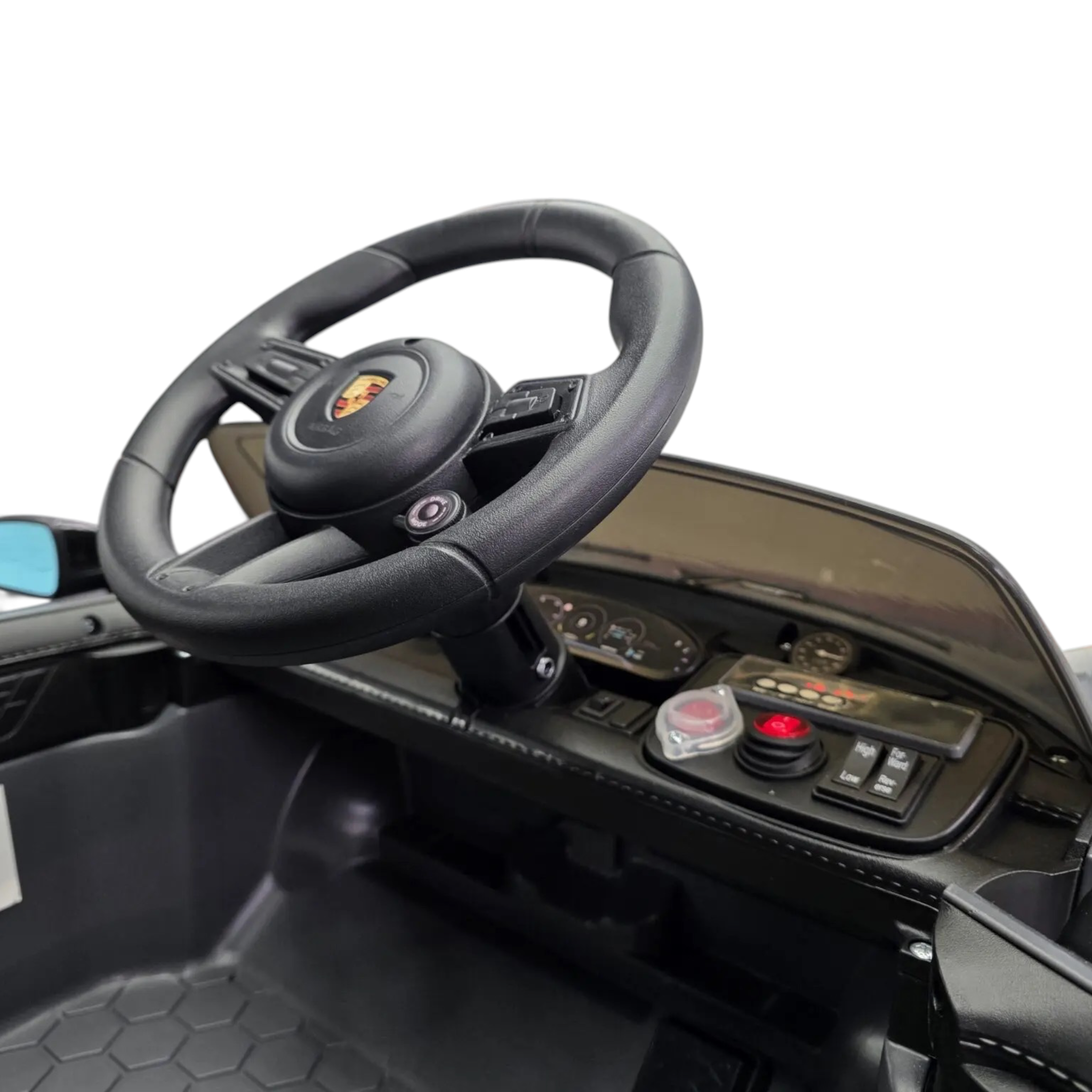 Vue intérieure du poste de pilotage de la voiture électrique Petit Pilote Porsche Taycan grise avec volant et tableau de bord