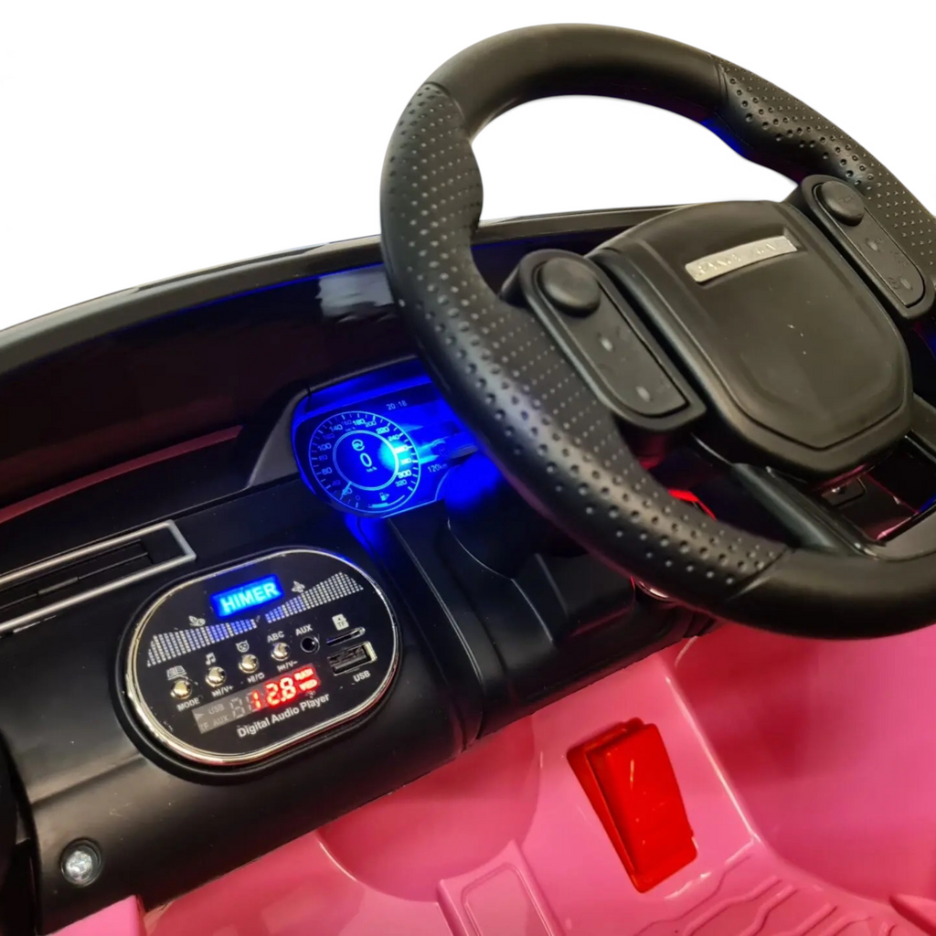 Tableau de bord de la voiture électrique enfant Petit Pilote Range Rover Velar rose avec volant et lecteur multimédia