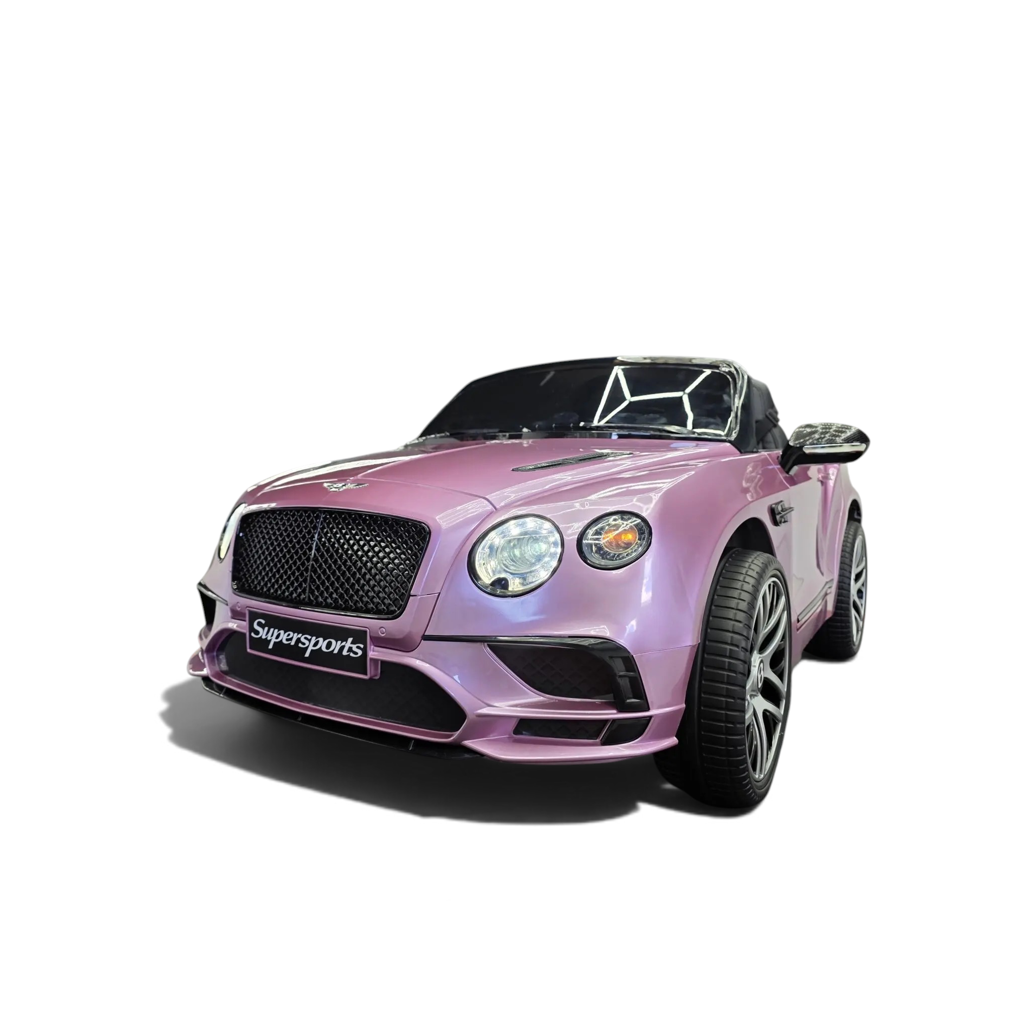 Voiture électrique enfant Odecare Bentley Continental rose métallisé avec phares fonctionnels dans un showroom