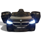 Voiture électrique enfant Petit Pilote BMW 6 GT noire métallisée avec phares LED allumés et portes ouvertes