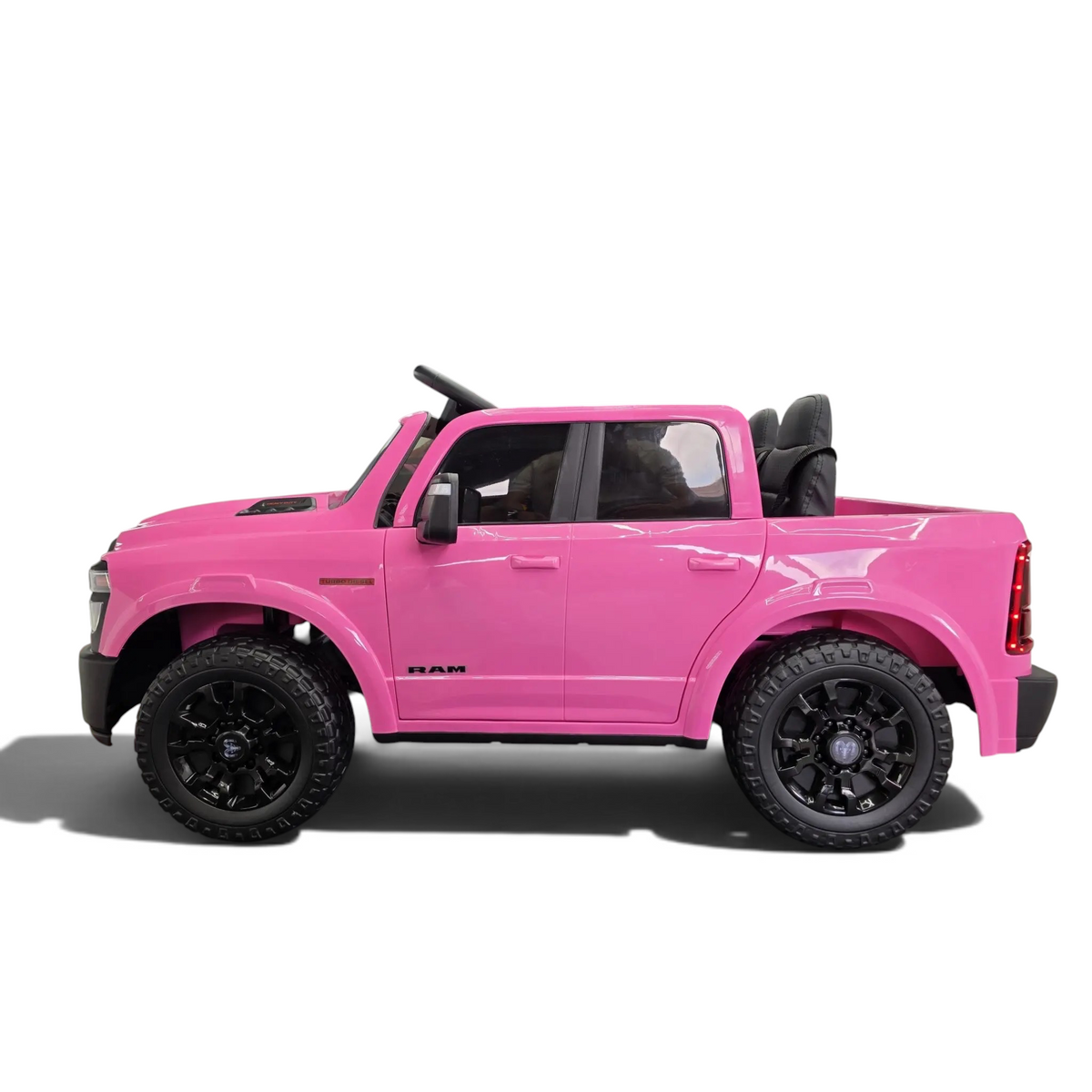 Voiture électrique enfant Odecare Dodge RAM rose 12V avec pneus EVA et siège en cuir dans un showroom