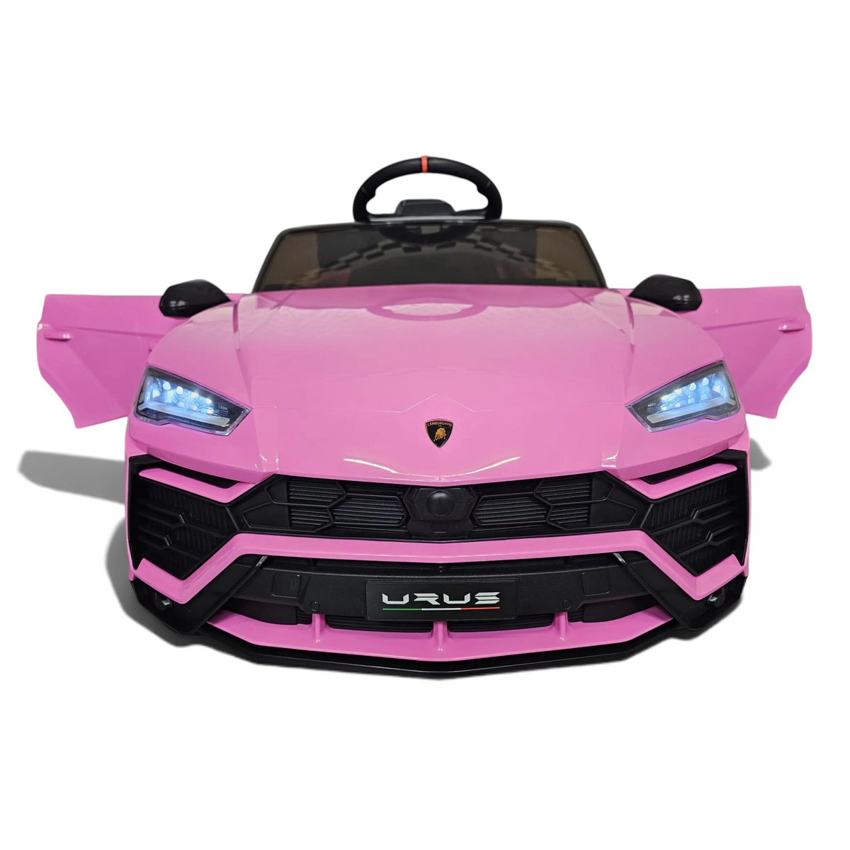 Voiture électrique enfant Petit Pilote Lamborghini Urus rose avec phares LED allumés, portes ouvertes et logo visible
